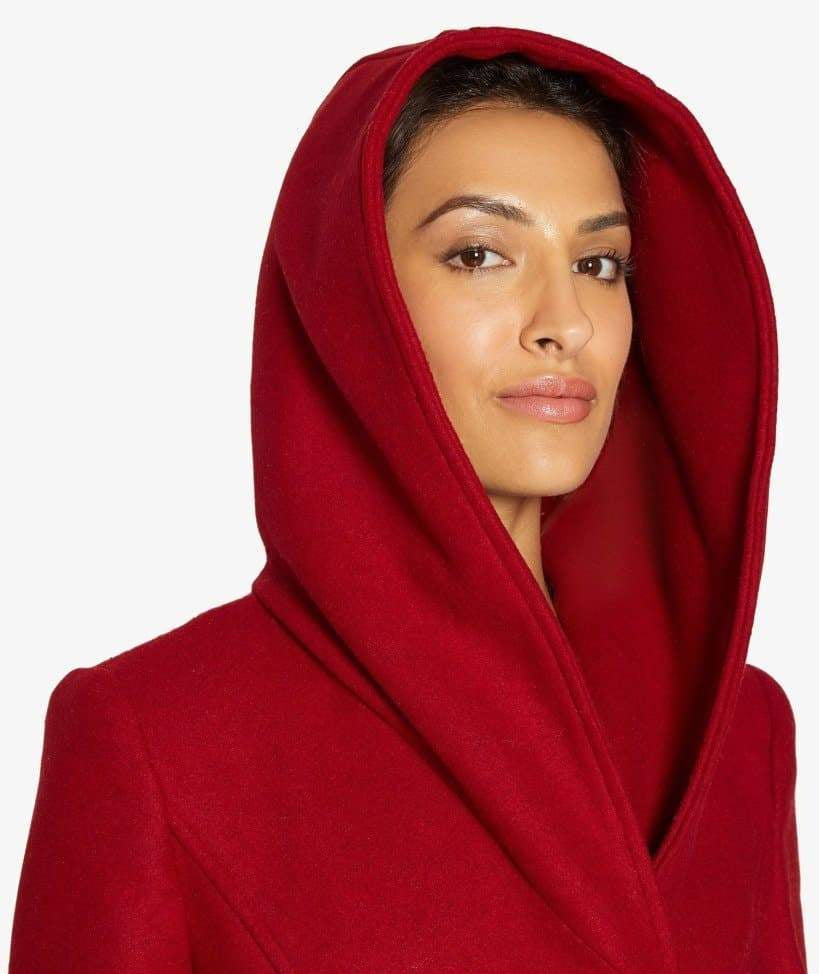 Woman wearing a red hooded garment.