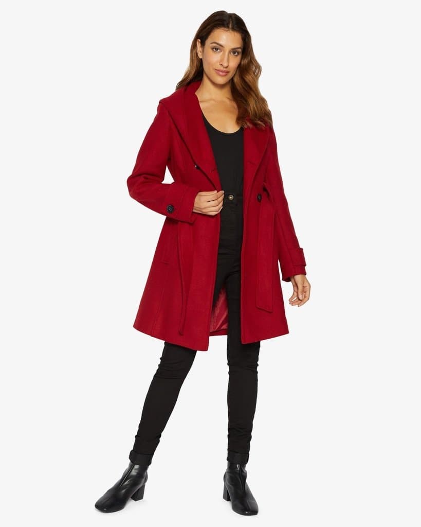 Woman wearing a red coat on a white background