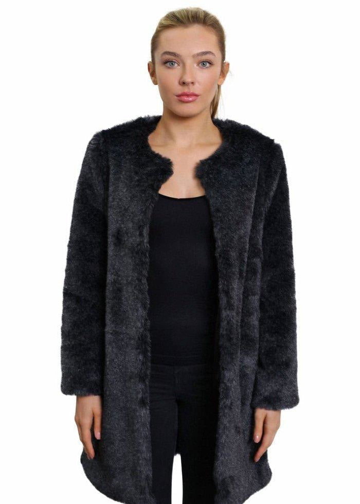 Woman wearing a dark gray fur coat on a white background