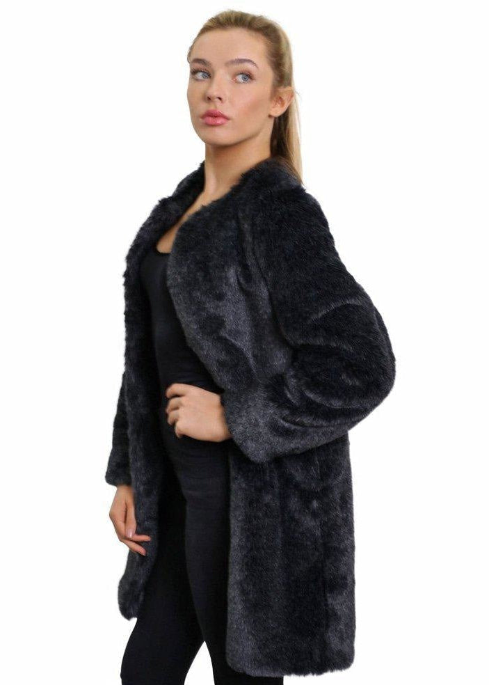 Woman wearing a dark gray fur coat on a white background