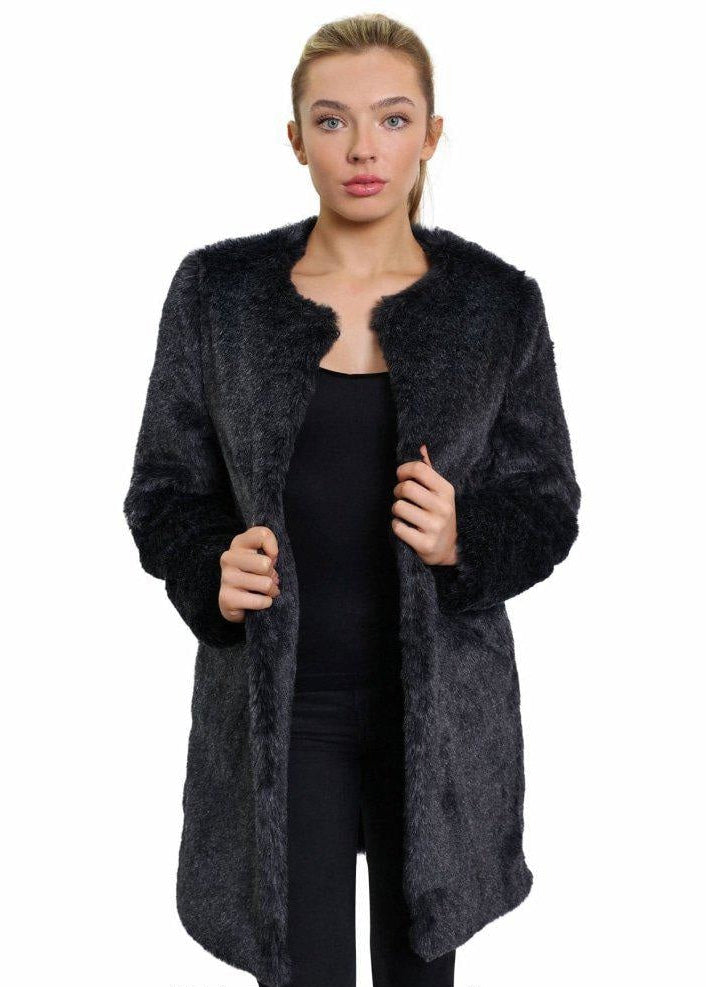 Woman wearing a dark gray fur coat on a white background