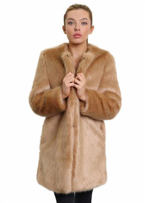 Woman wearing a beige fur coat on a white background