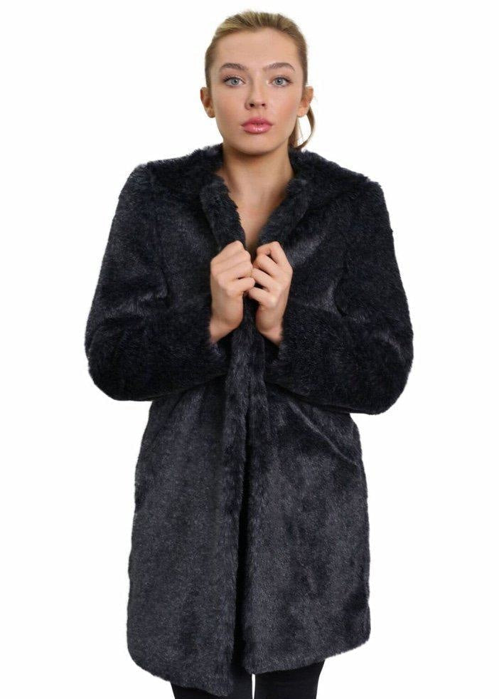 Woman wearing a black fur coat on a white background