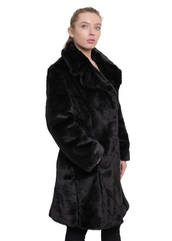 Woman wearing a black fur coat on a white background