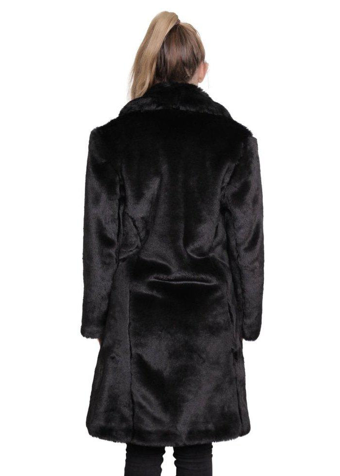 Person wearing a black fur coat