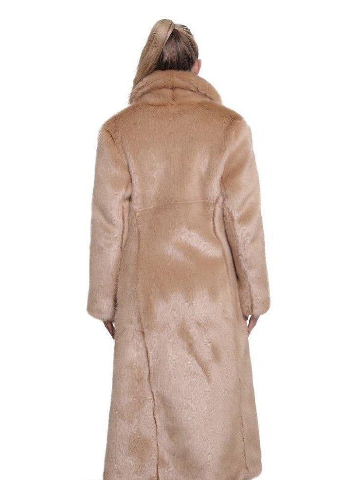 Beige fur coat worn by a person on a white background, with branding.