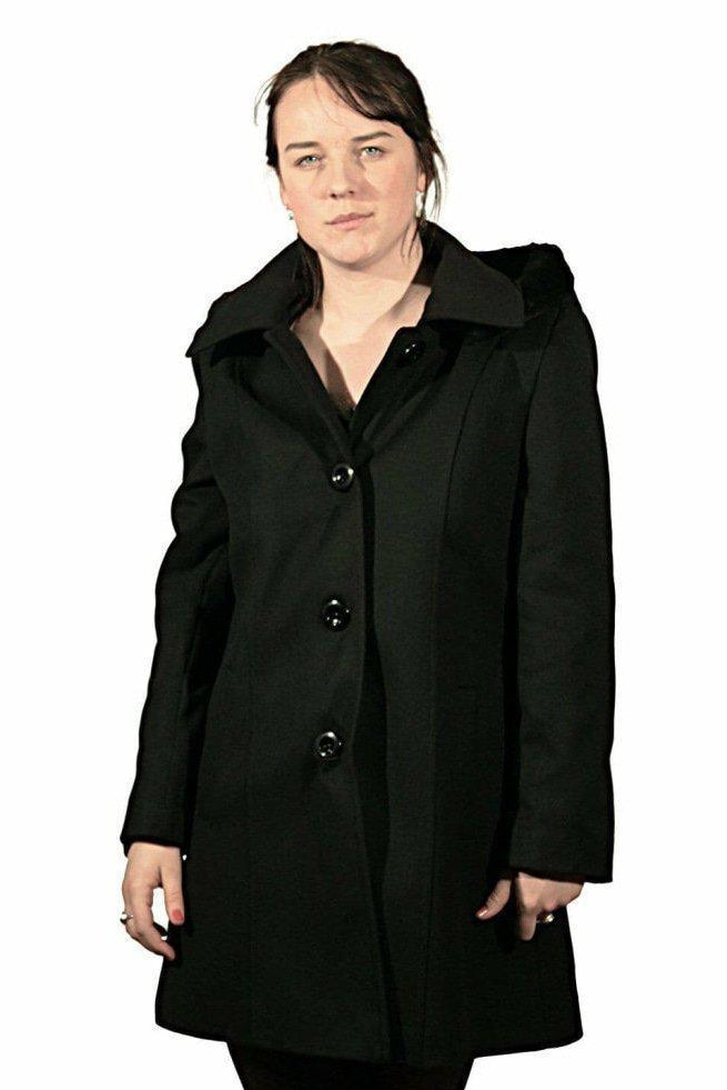 Woman wearing a black coat on a white background