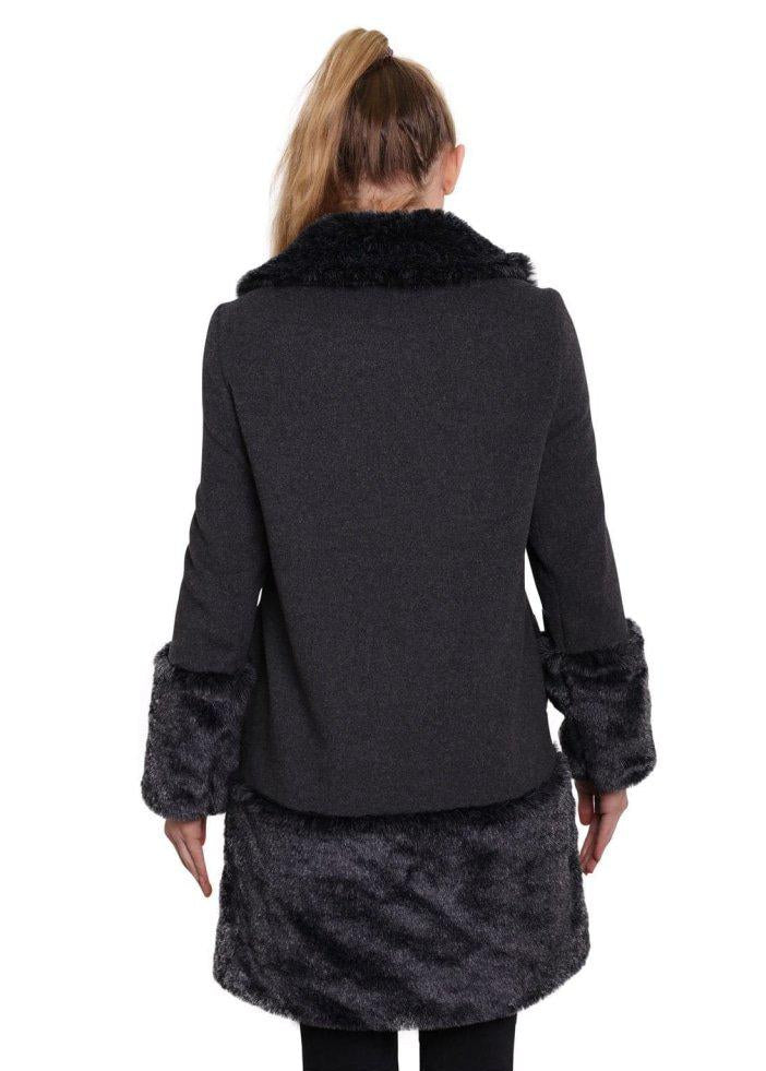 Black coat with fur trim on cuffs and collar worn by a model on a white background