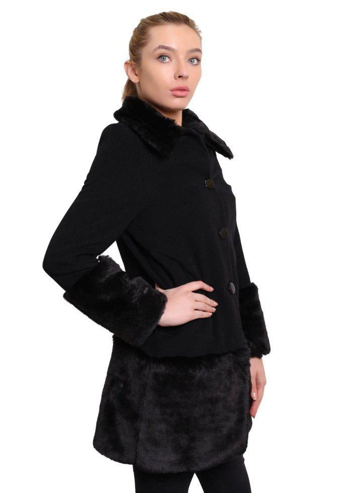 Woman wearing a black coat with fur trim on a white background