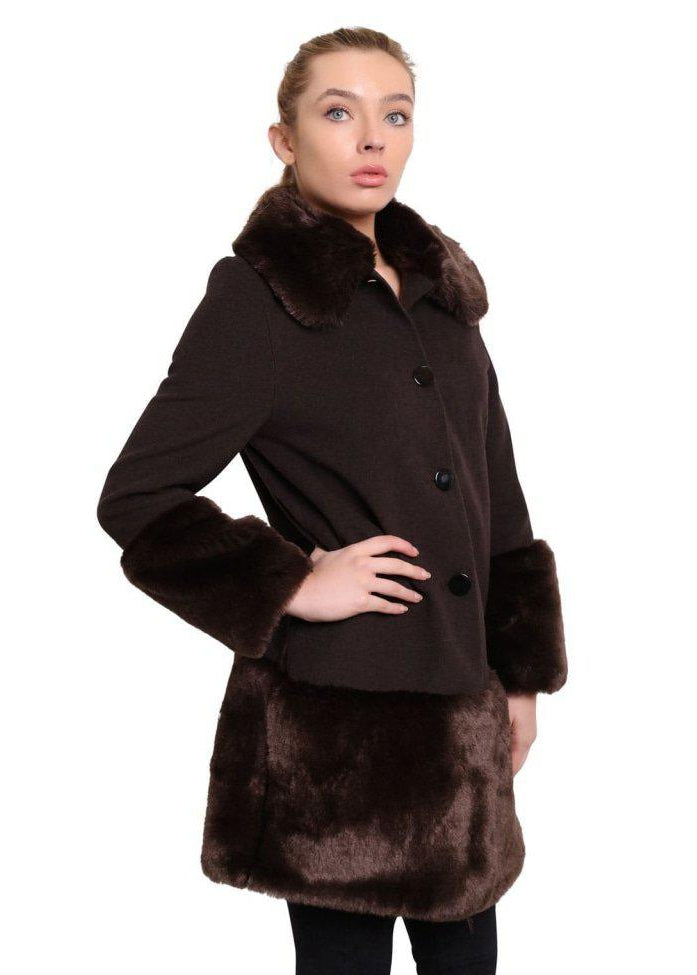 Woman wearing a brown coat with fur trim on a white background