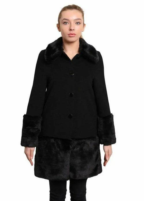 Woman wearing a black coat with fur trim on a white background