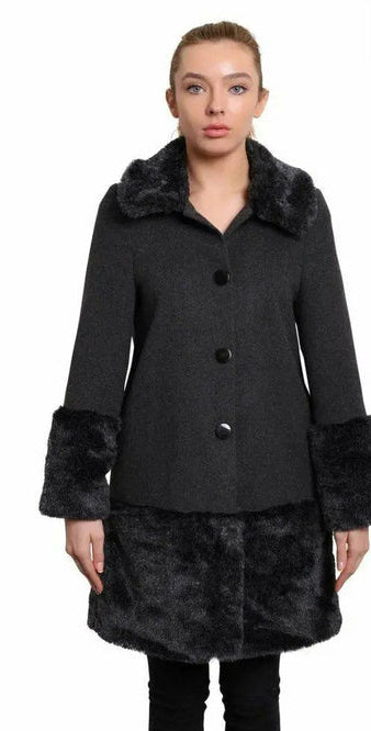 Woman wearing a black coat with fur trim on a white background