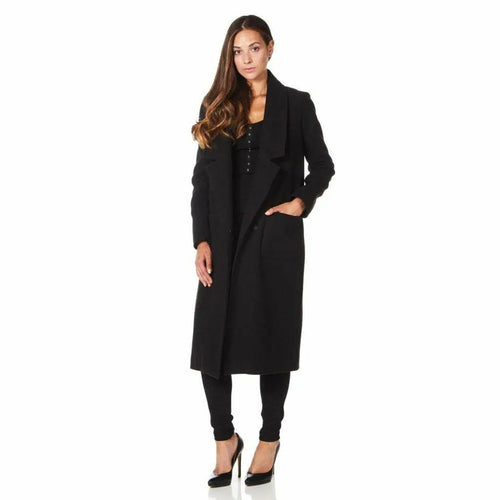 Woman wearing a black coat on a white background