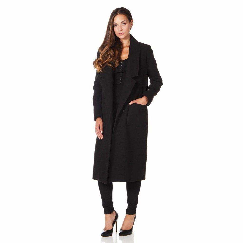 Woman wearing a black coat on a white background