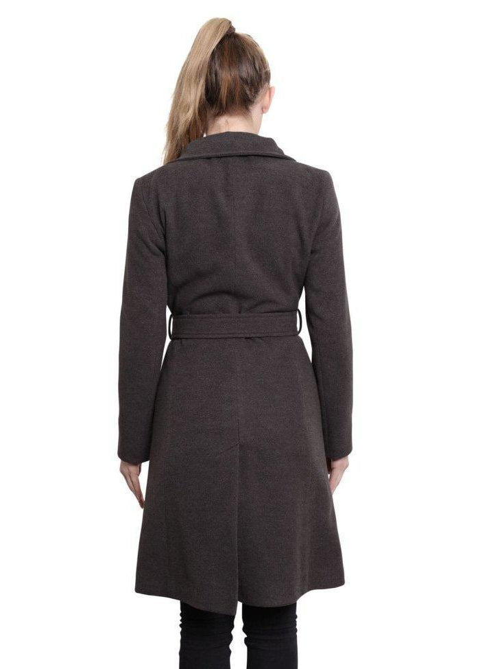 Woman wearing a long brown coat on a white background