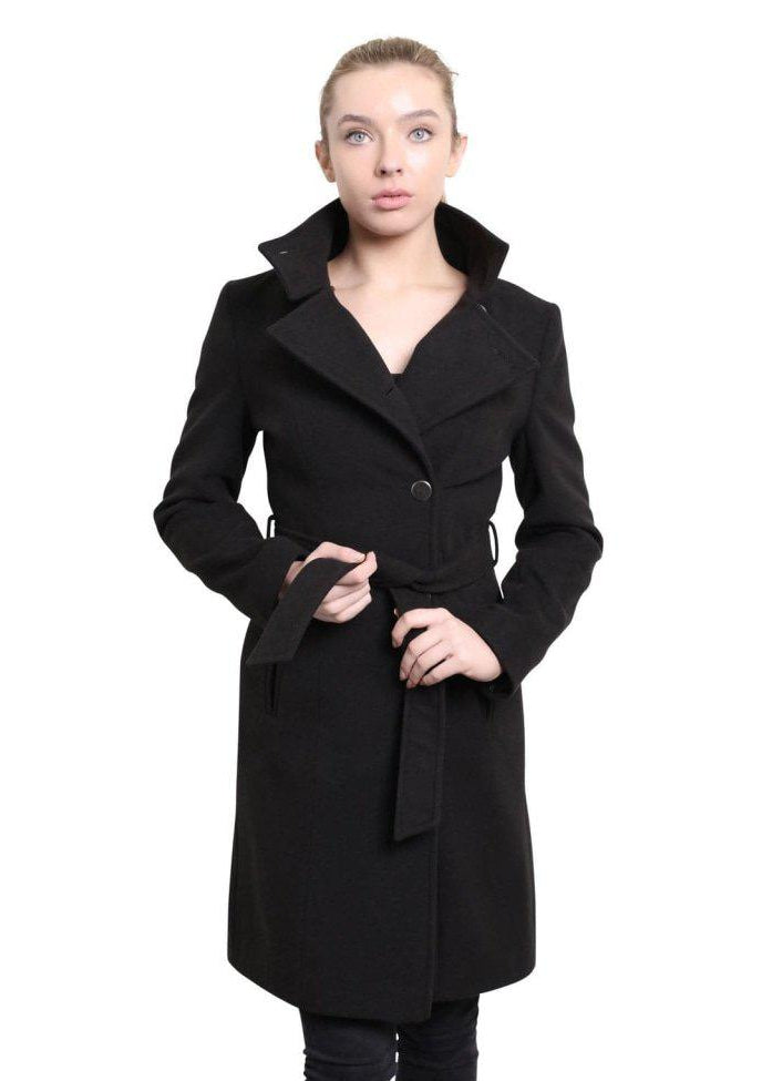 Woman wearing a black coat with a white background