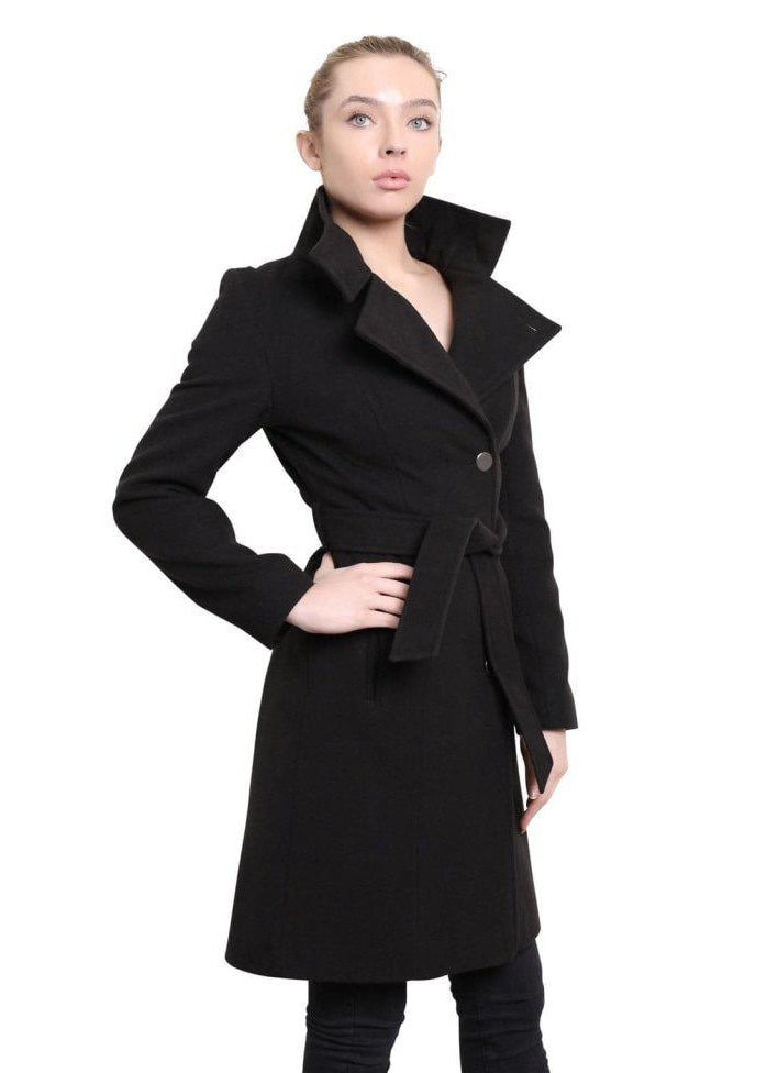 Woman wearing a black coat with a belt on a white background