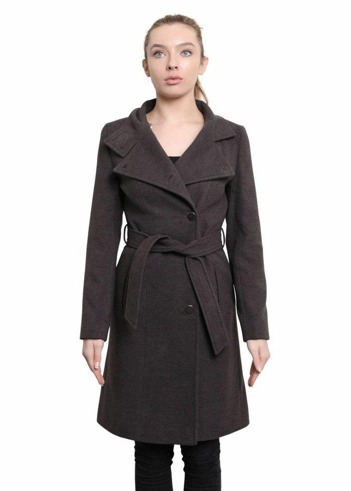Woman wearing a dark brown coat with a belt on a white background