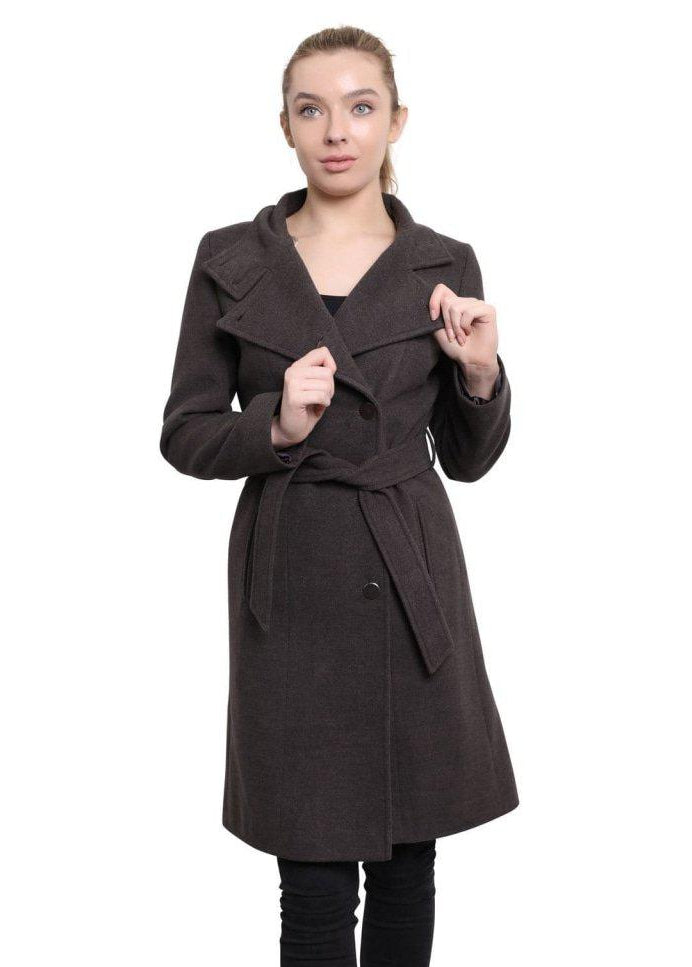 Woman wearing a brown coat with a white background