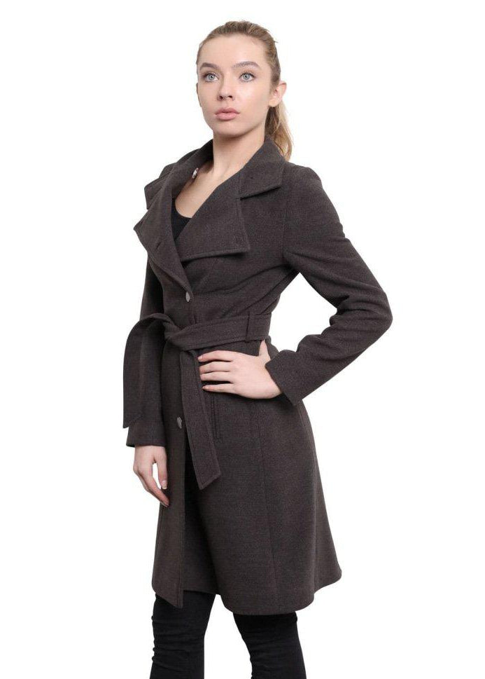 Woman wearing a brown coat with a white background