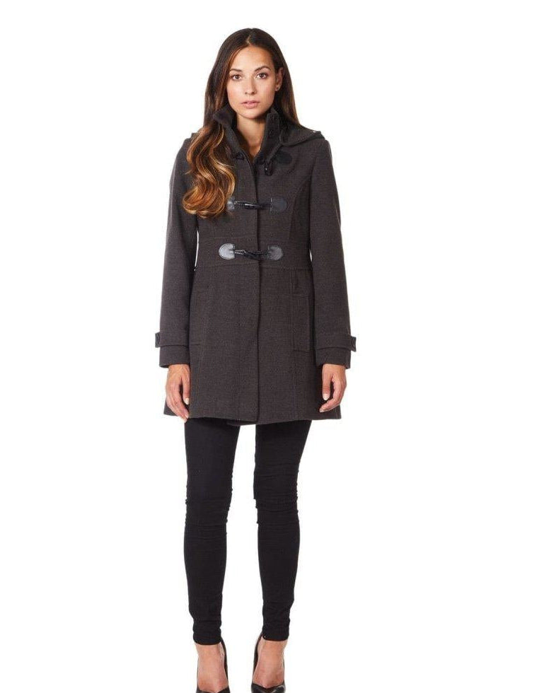 Woman wearing a dark gray coat with black buttons on a white background.