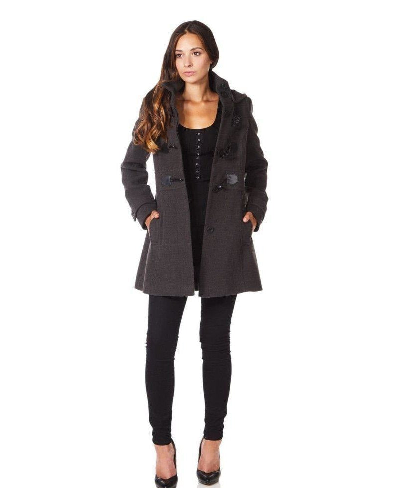 Woman wearing a gray coat with a white background.