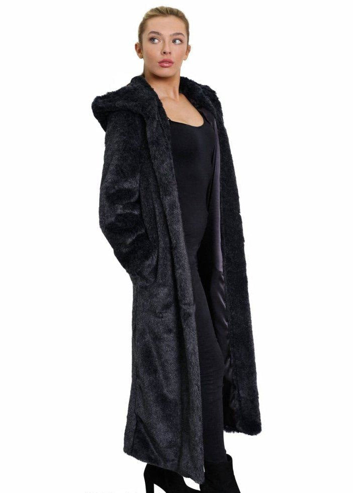 Person wearing a long black coat on a white background