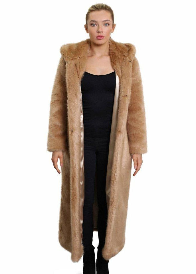 Woman wearing a long fur coat on a white background
