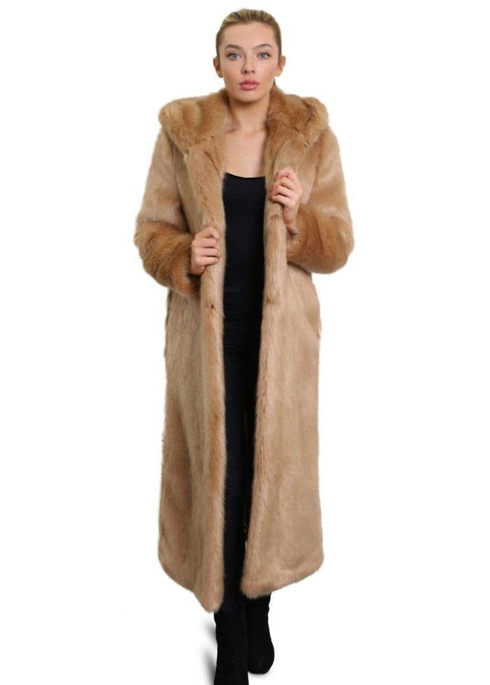 Woman wearing a long fur coat on a white background