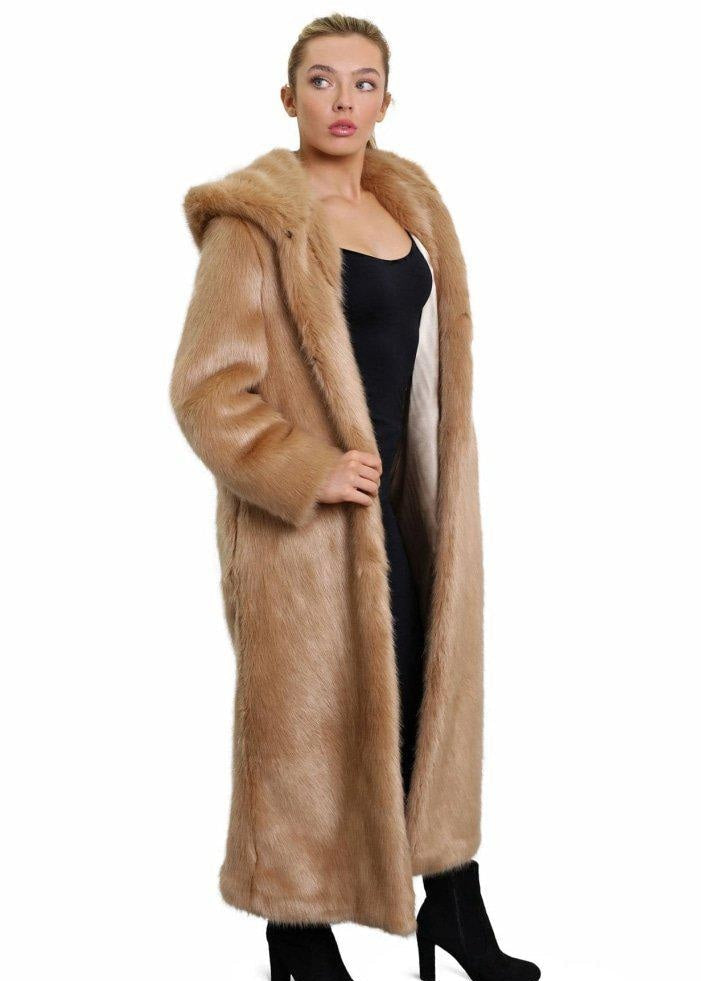 Woman wearing a long fur coat with a hood on a white background