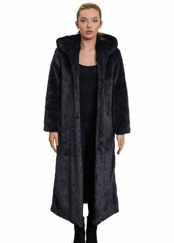 Woman wearing a long dark coat on a white background