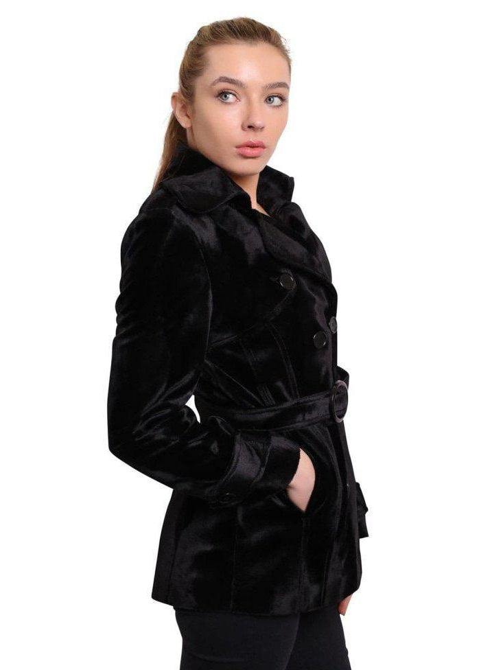 Woman wearing a black velvet coat on a white background