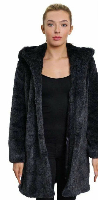 Woman wearing a dark gray hooded coat with a white background