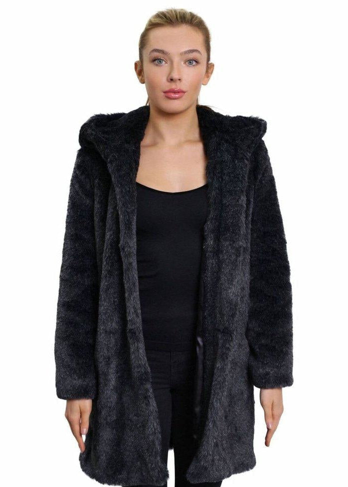 Woman wearing a dark gray fur coat on a white background