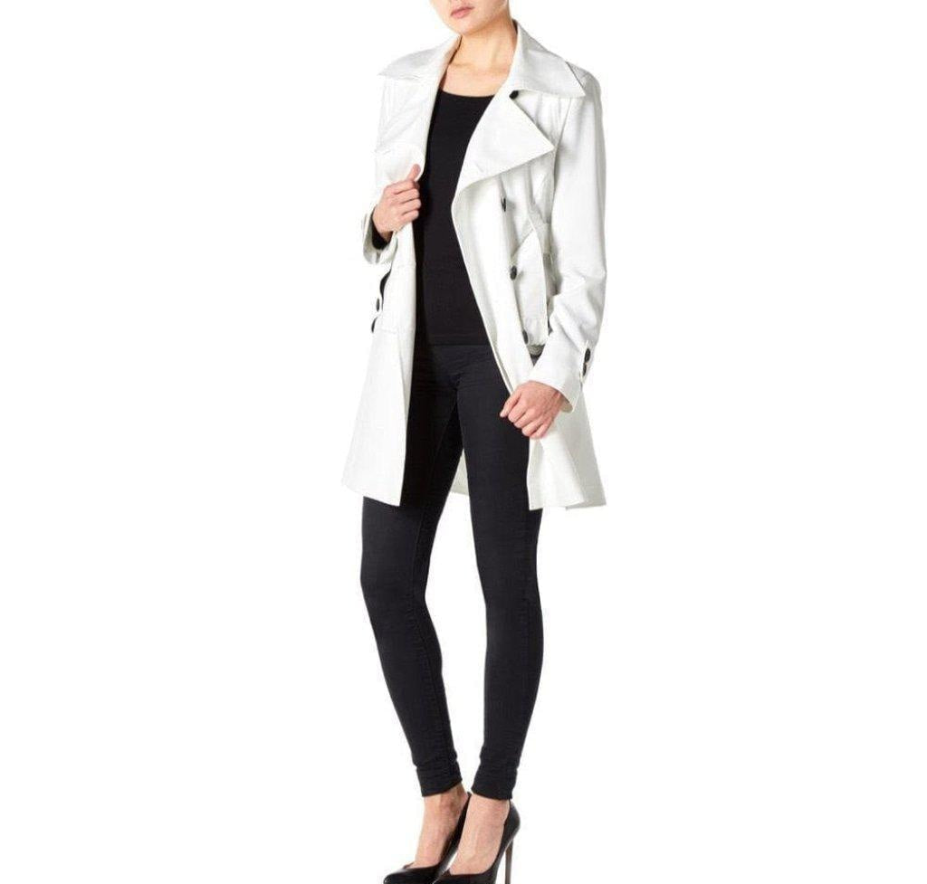 Person wearing a white coat over a black outfit on a white background