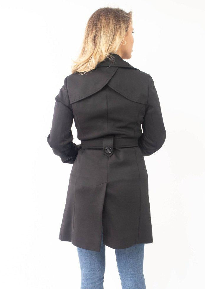 Woman wearing a black coat on a white background