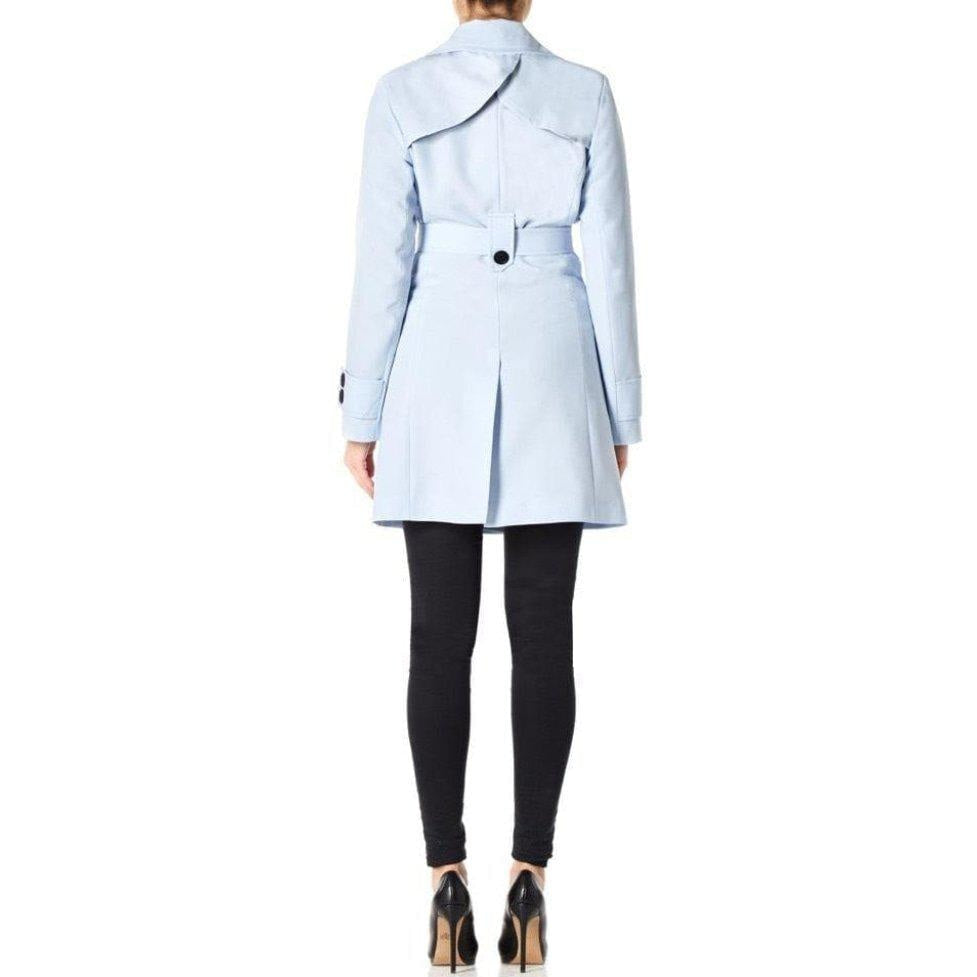 Light blue trench coat worn by a person on a white background