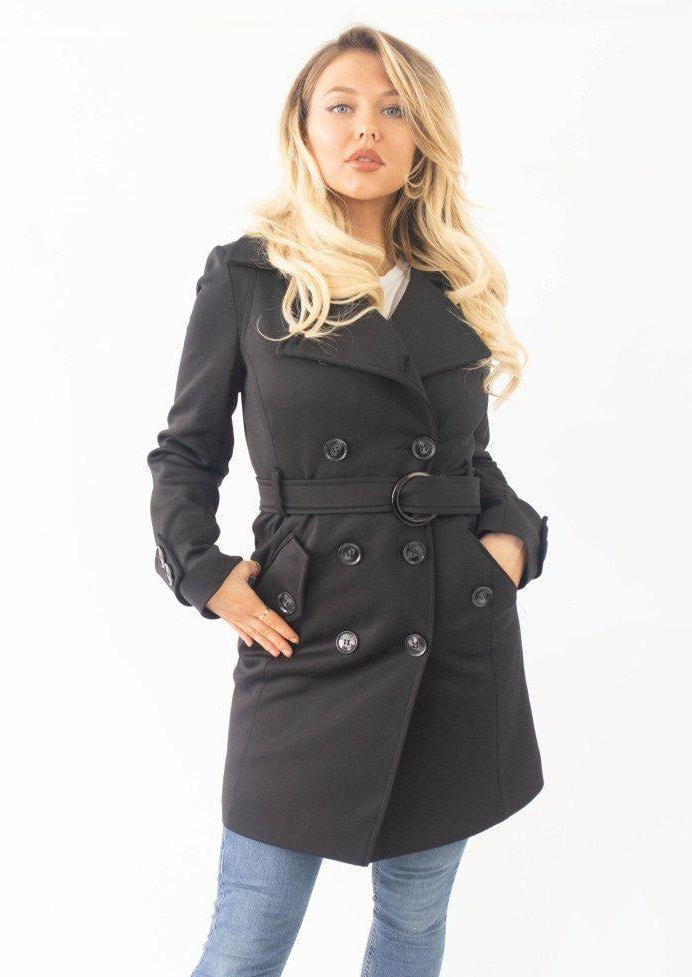 Woman wearing a black coat with a white background