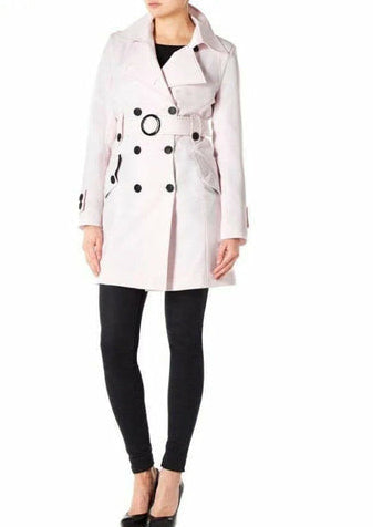 White trench coat with black buttons worn by a person on a white background