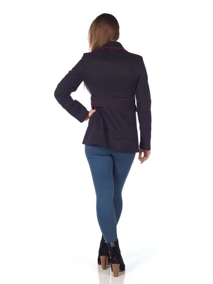 Woman wearing a dark blue jacket and blue jeans on a white background