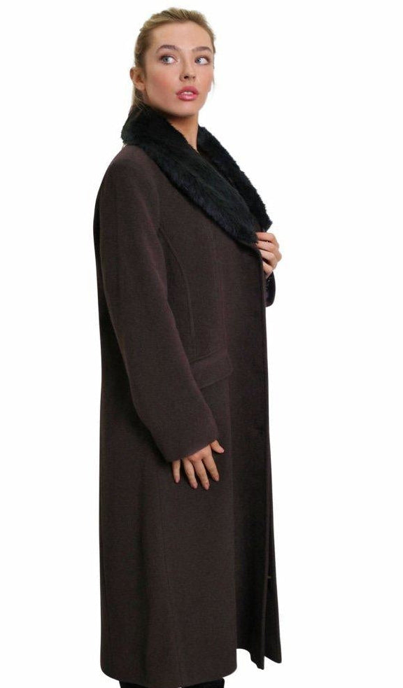 Woman wearing a long brown coat with a black scarf on a white background