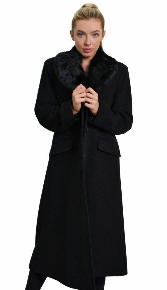 Woman wearing a black coat with fur collar on a white background