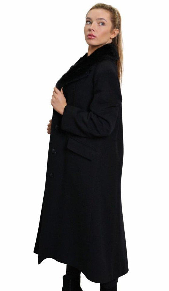 Woman wearing a black coat on a white background