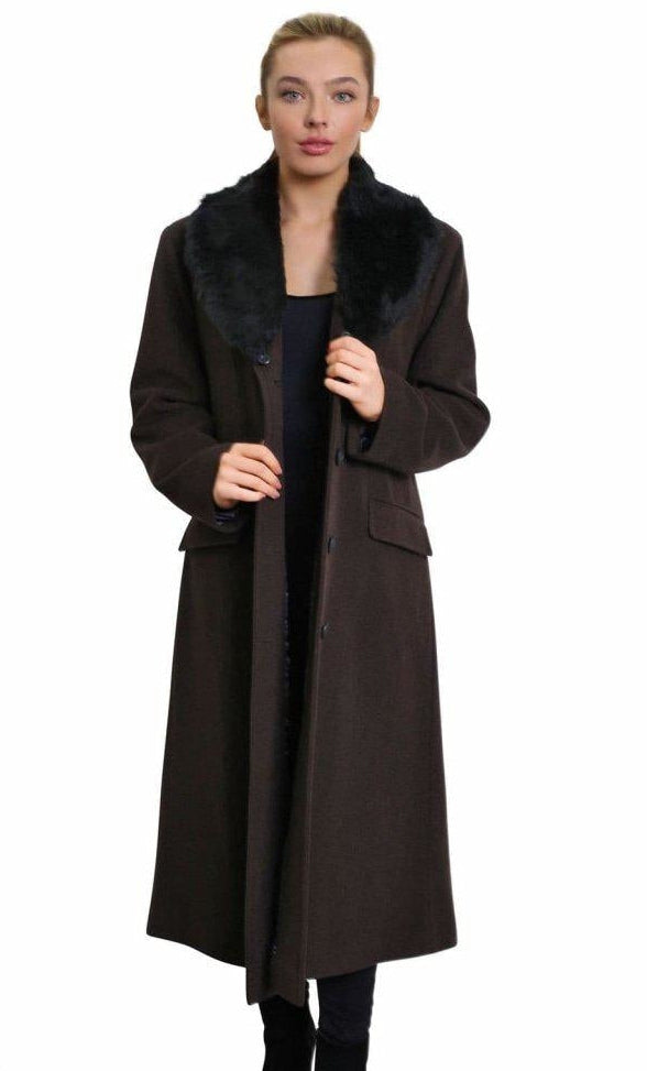 Woman wearing a long brown coat on a white background
