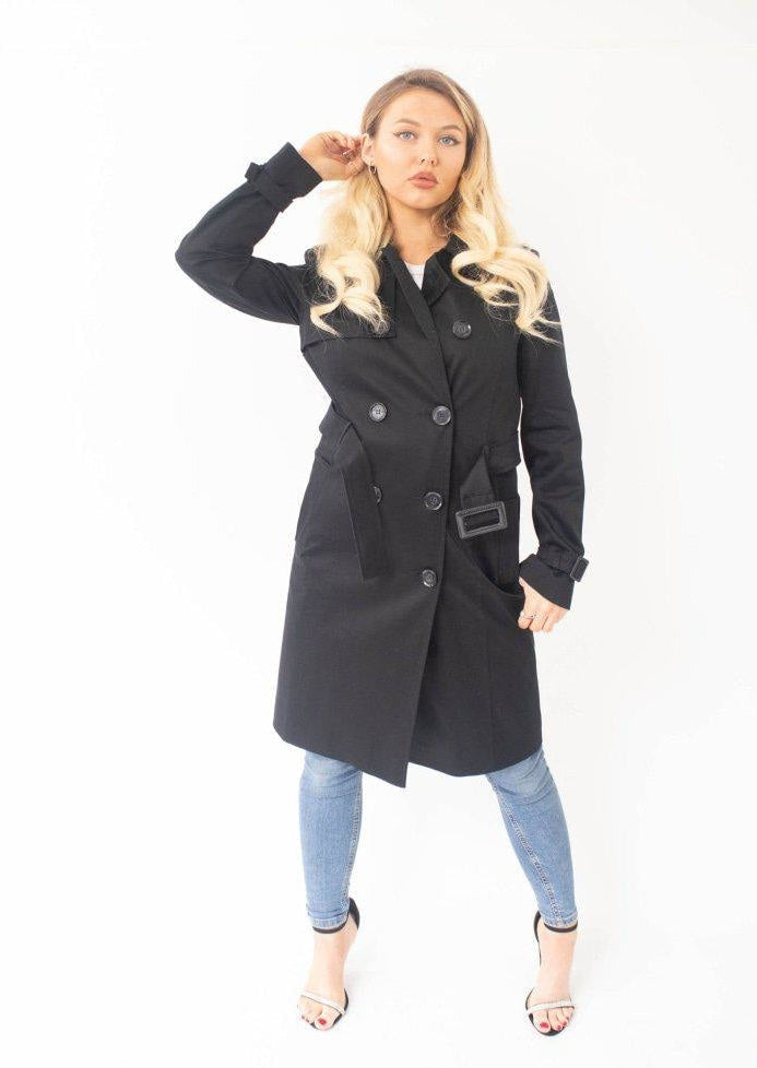 Woman wearing a black coat on a white background