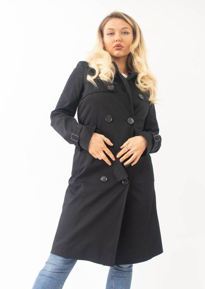 Woman wearing a black coat on a white background