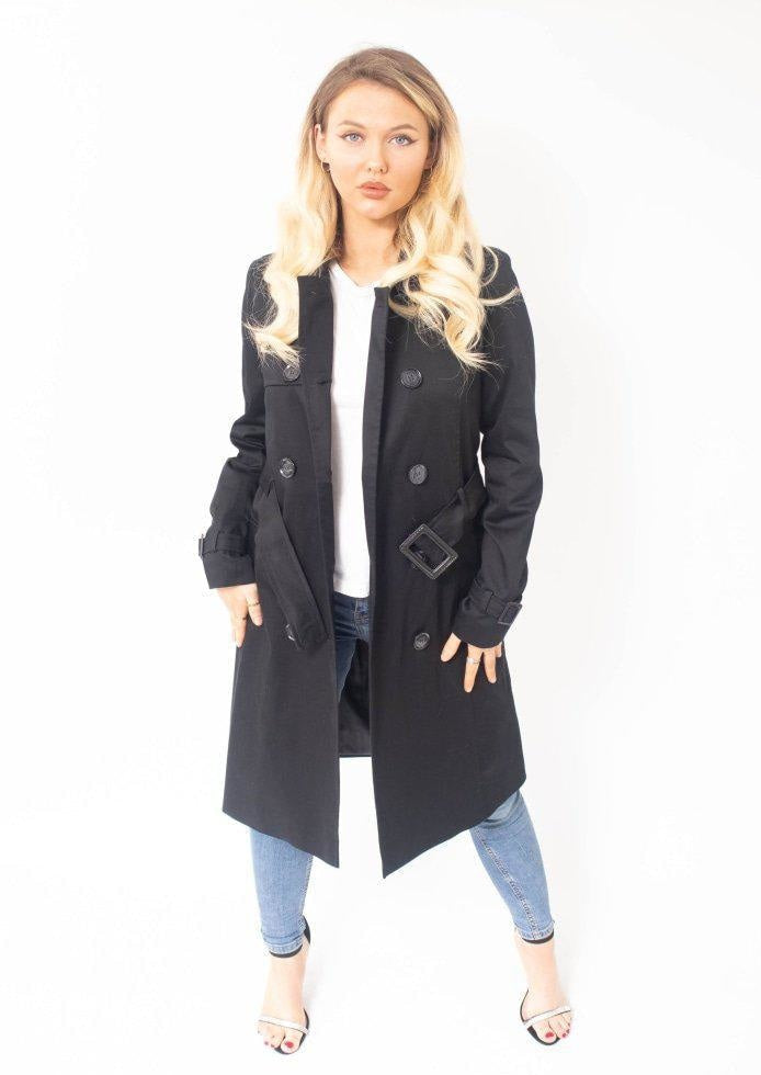 Woman wearing a black coat with a white background