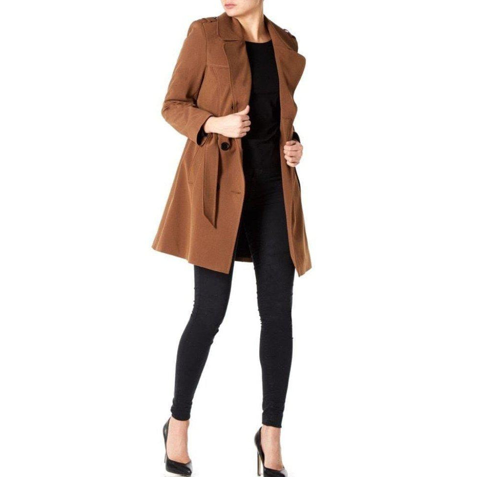 Person wearing a brown coat over a black outfit on a white background