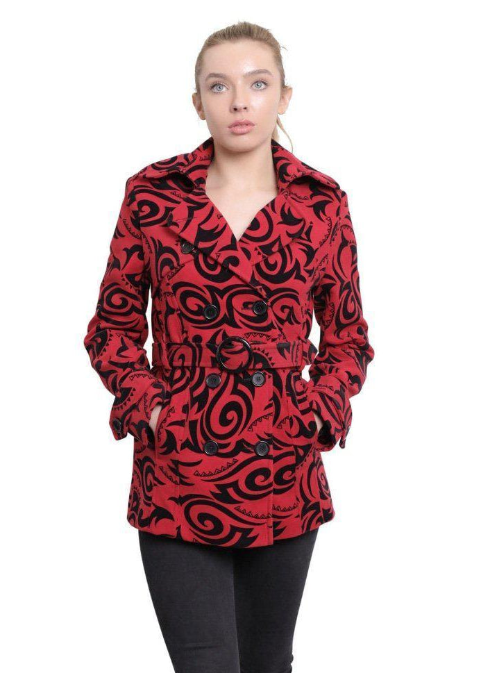 Woman wearing a red patterned coat with a white background