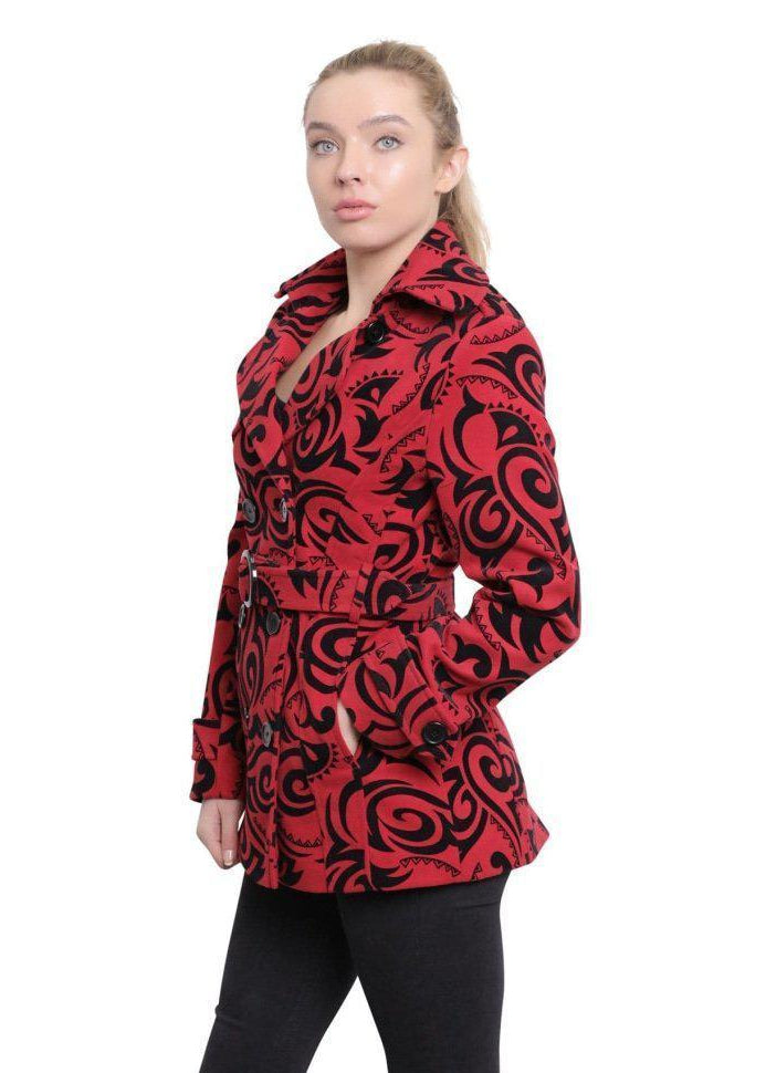 Woman wearing a red and black patterned coat on a white background